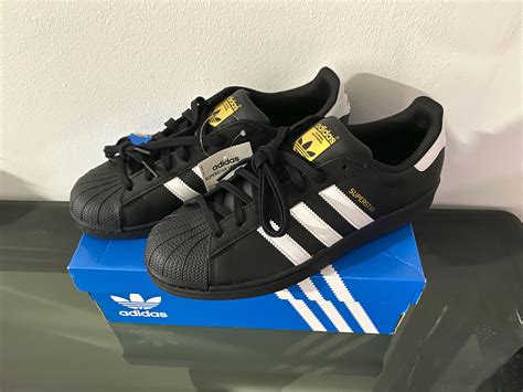 adidas superstar black sneakers.